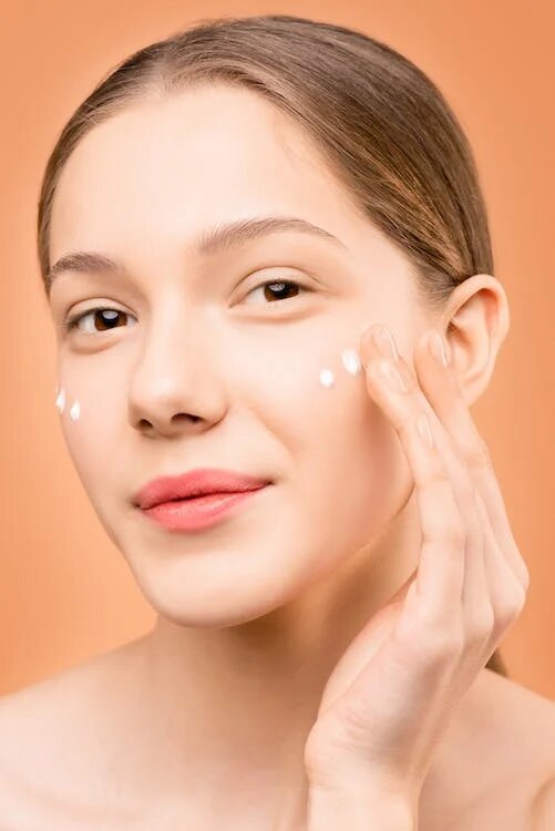 mujer echándose vitamina C en la cara
